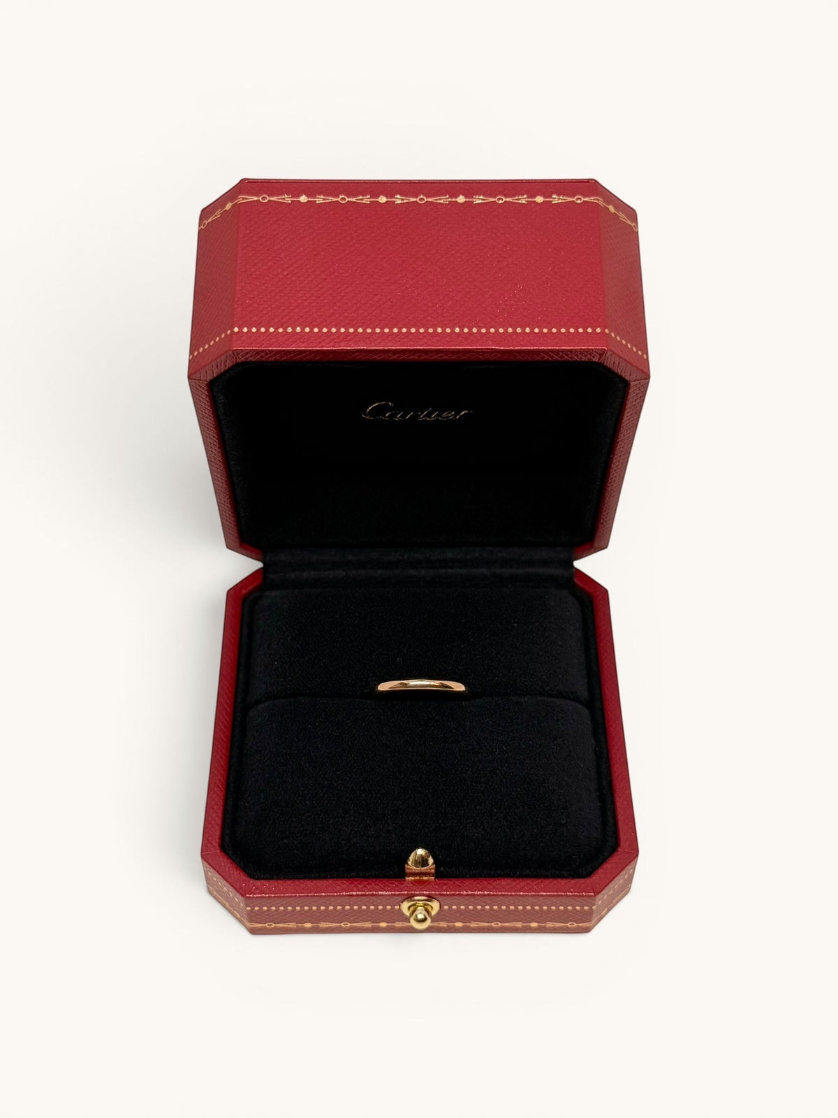 By the Hour Cartier 1895 wedding band in pink gold, 2.5mm wide, presented in a red Cartier ring box.