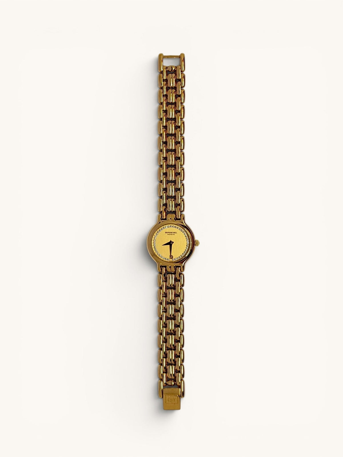 By the Hour vintage gold-tone Raymond Weil Fidelio watch with diamond dial and date window at 6 o'clock. Features a linked bracelet and Swiss quartz movement.
